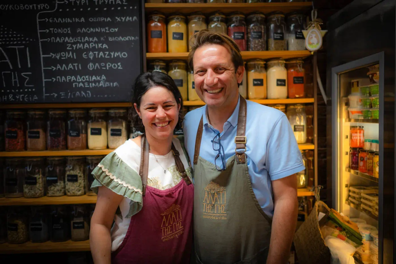 Maria and Dimitris in front of the counter in "Alati tis Gis"